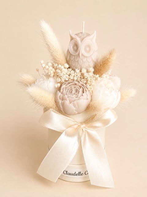 Elegant cream floral arrangement with ceramic owl, pampas grass, and babys breath in a vase with cream ribbon bow