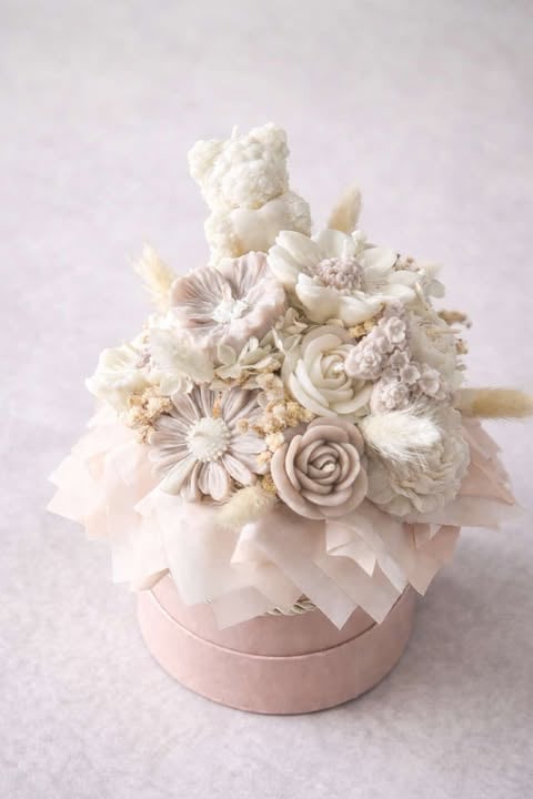 Luxury flower arrangement with cream and blush roses, daisies, and a decorative bear on top in a pink box